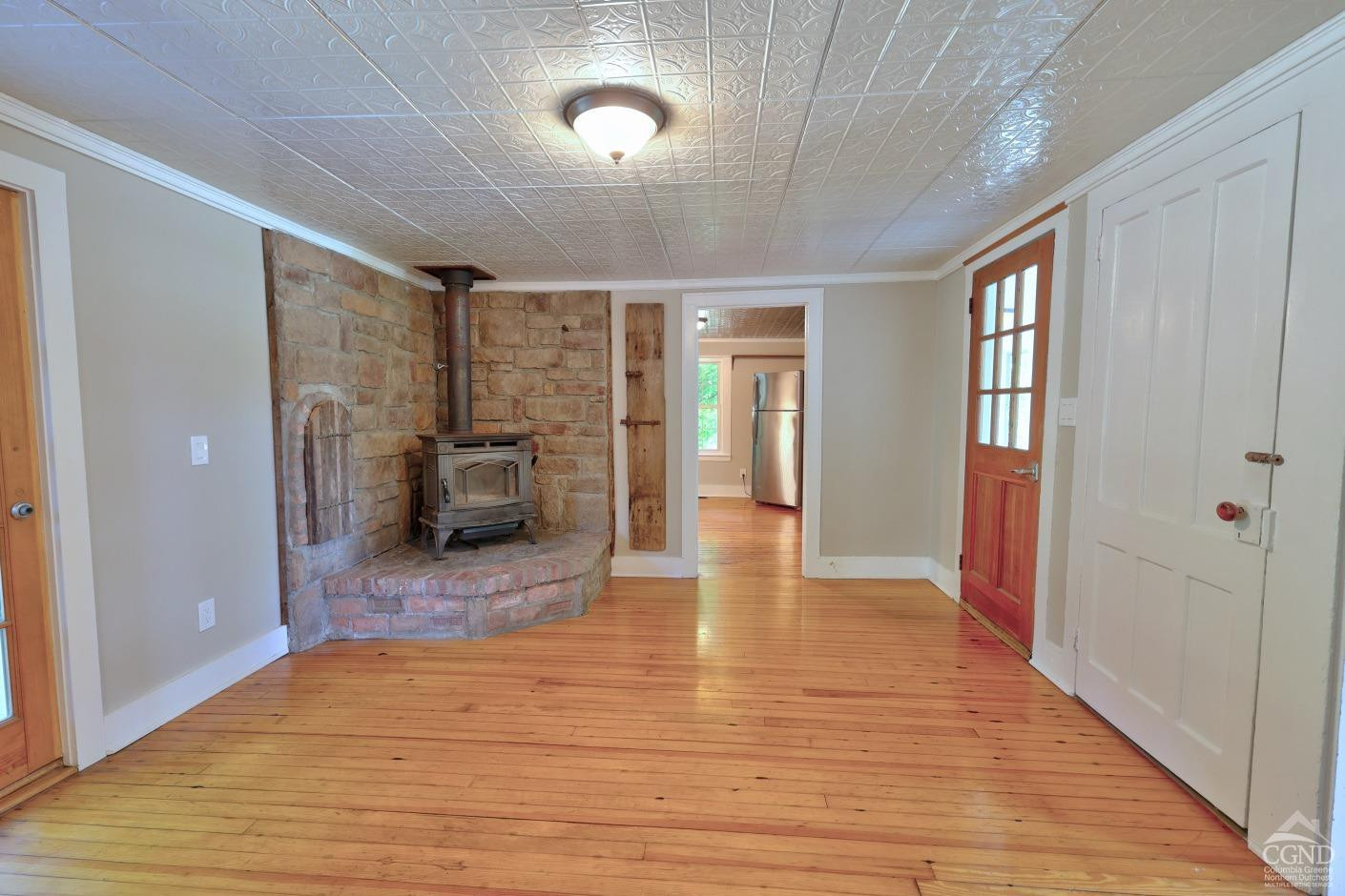 21 Irondale Road Millerton, NY 12546 - Photo 19 of 73 a view of an entryway of a house and empty room with wooden floor