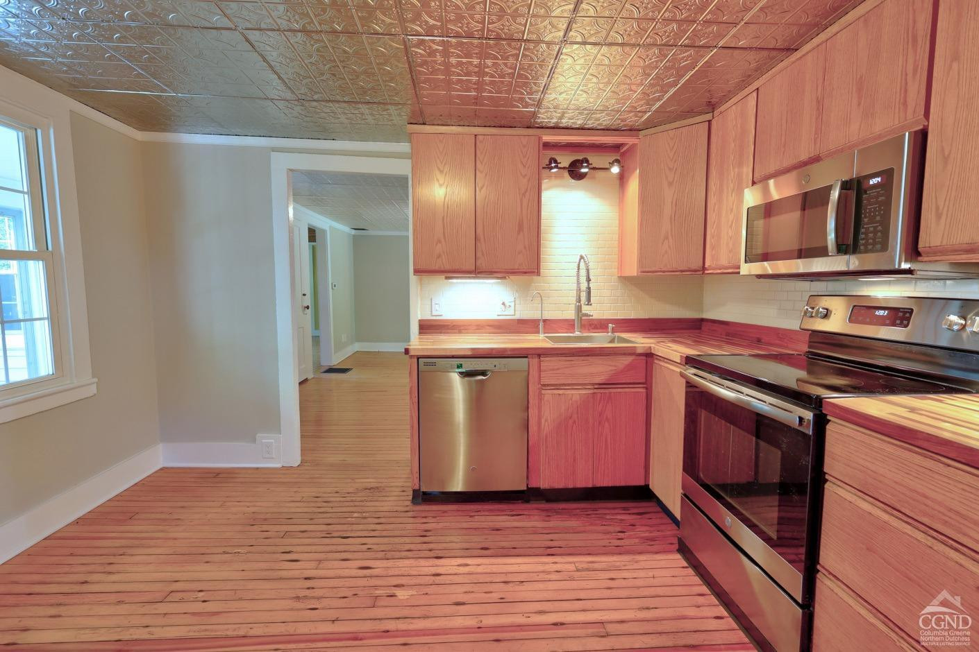 21 Irondale Road Millerton, NY 12546 - Photo 21 of 73 a kitchen with stainless steel appliances granite countertop a sink a stove and a wooden floors