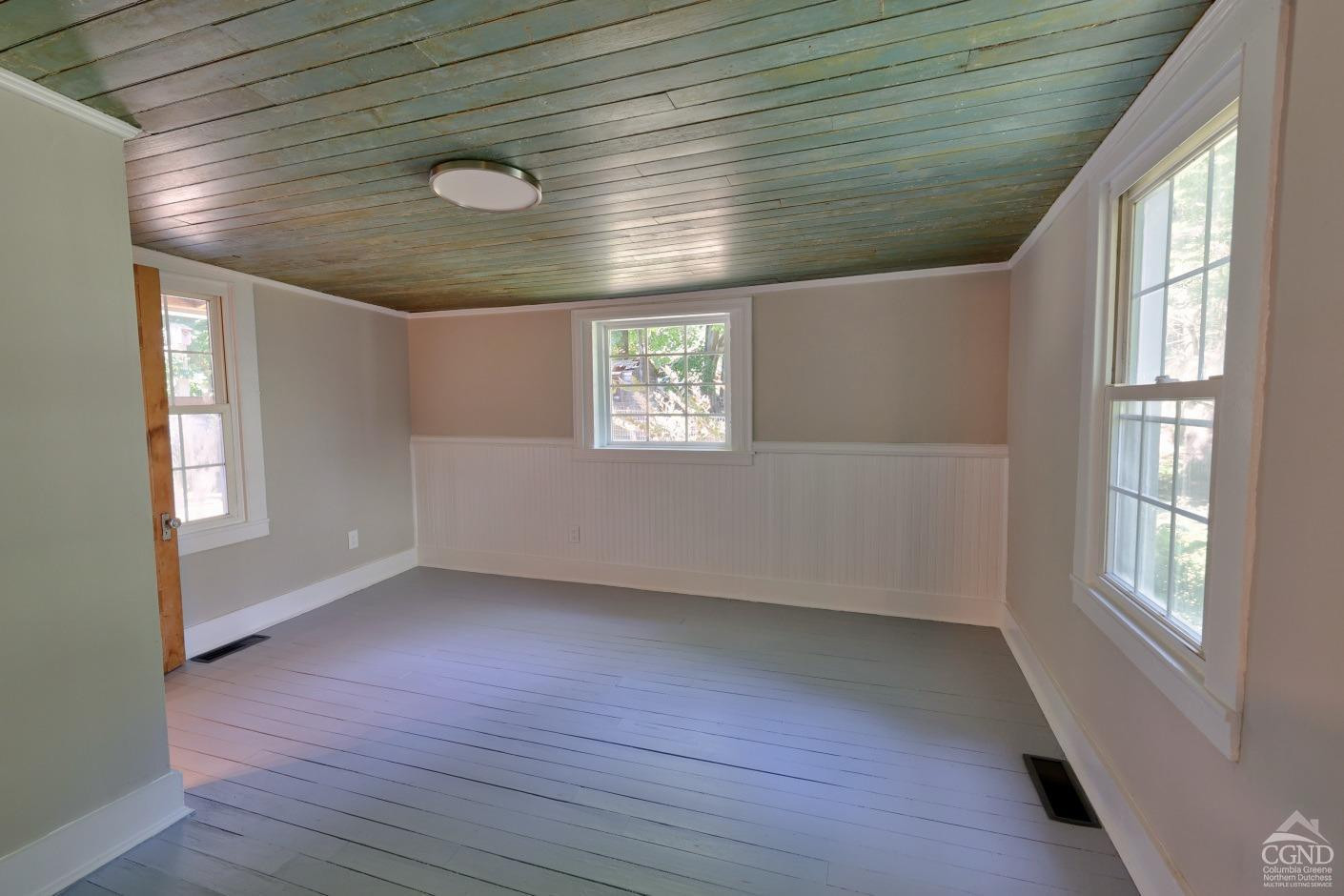 21 Irondale Road Millerton, NY 12546 - Photo 28 of 73 a view of an empty room with wooden floor and a window