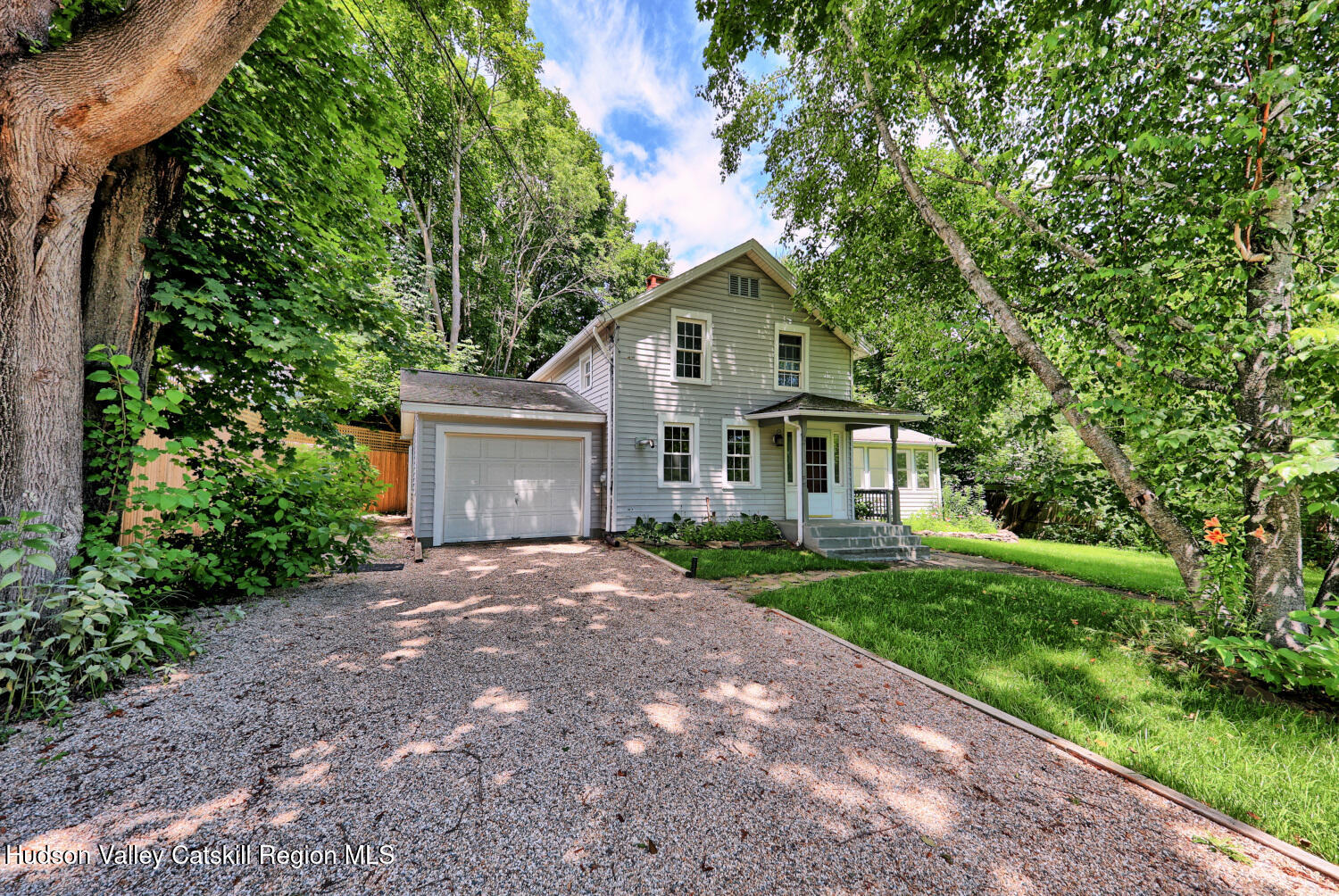 21 Irondale Road Millerton, NY 12546 - Photo 9 of 73 a front view of a house with a garden and trees