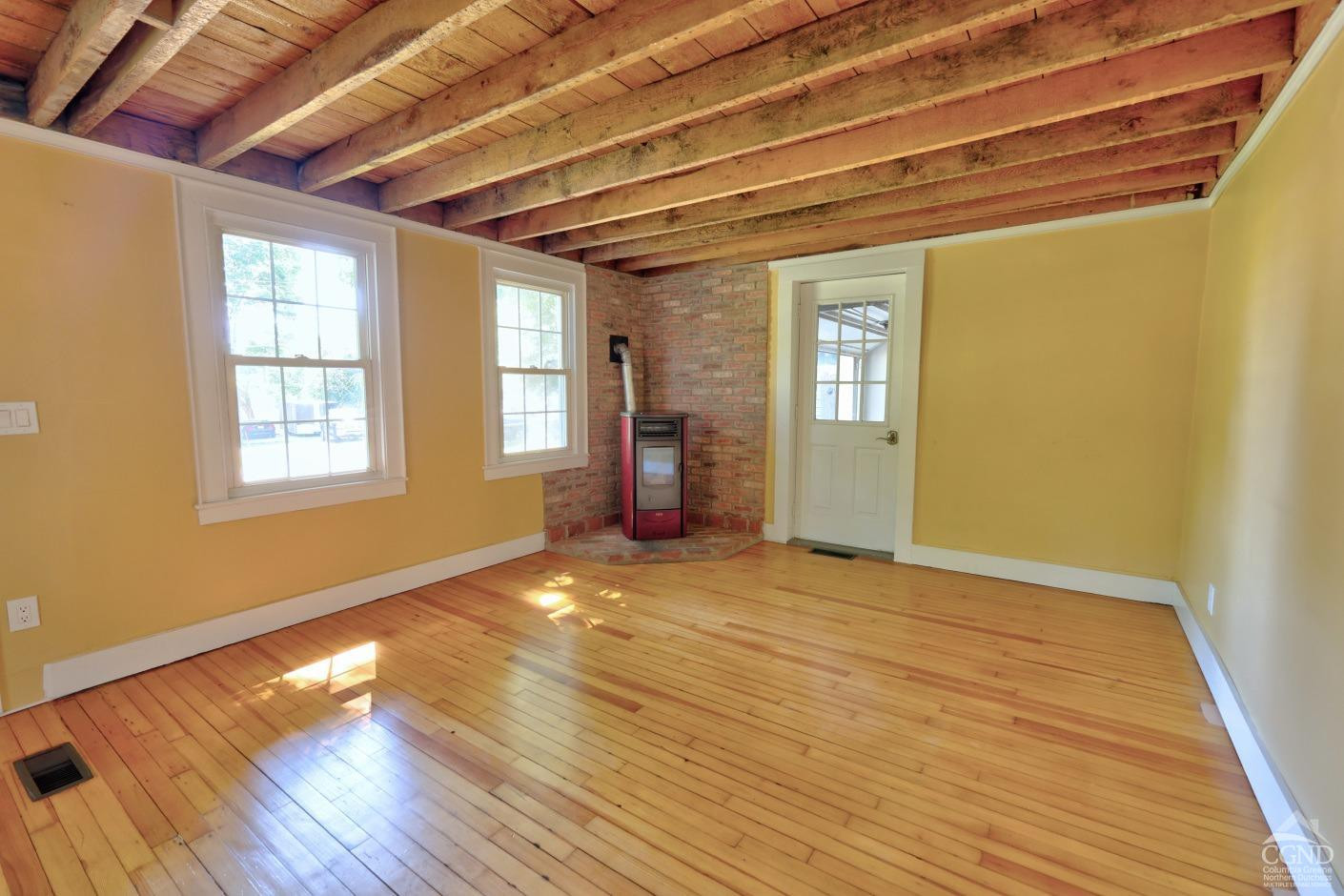 21 Irondale Road Millerton, NY 12546 - Photo 10 of 73 a view of an empty room with wooden floor and a window