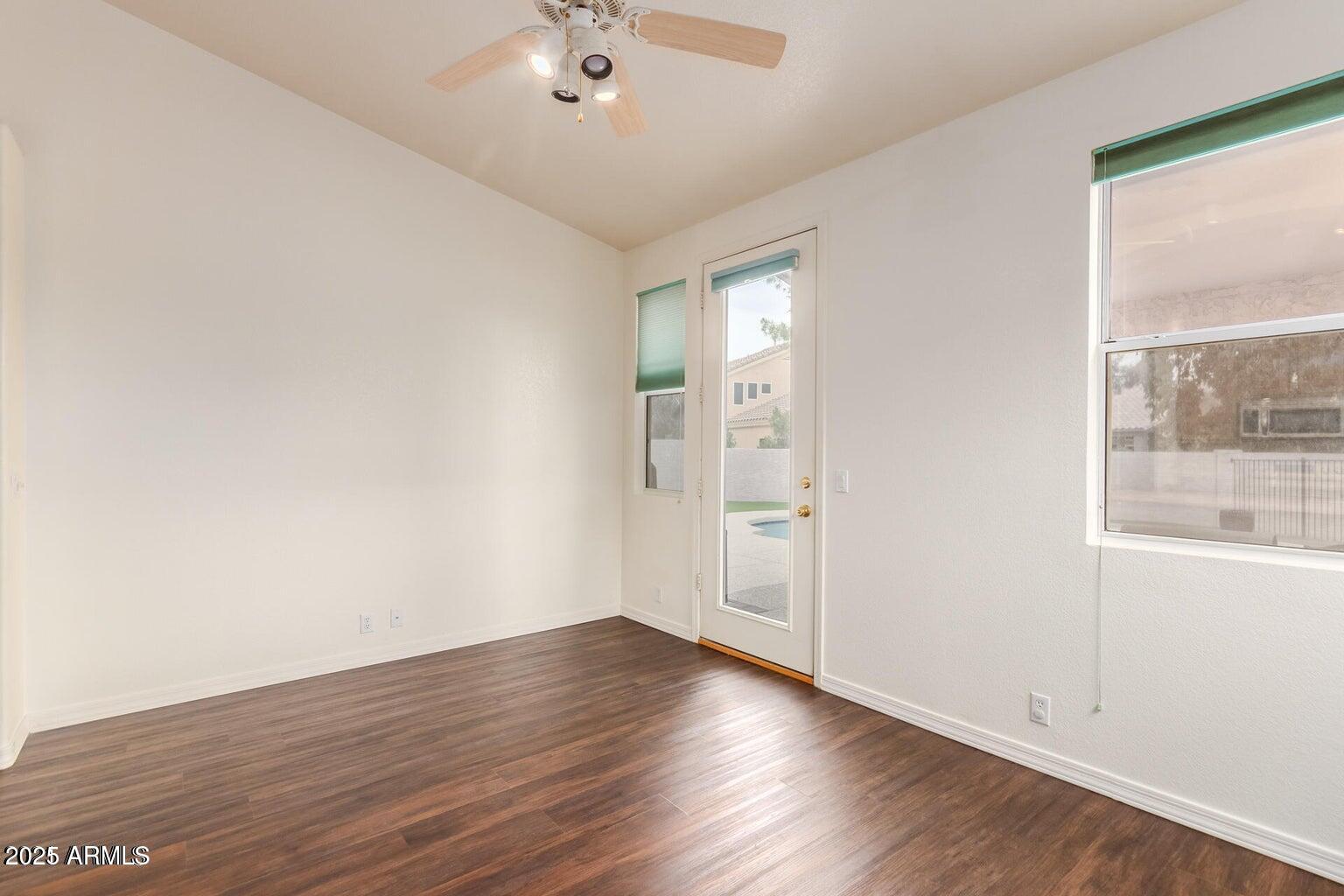 6230 West Irma Lane Glendale, AZ 85308 - Photo 17 of 21 an empty room with wooden floor and windows