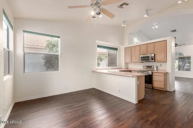 a kitchen with a refrigerator and a stove top oven