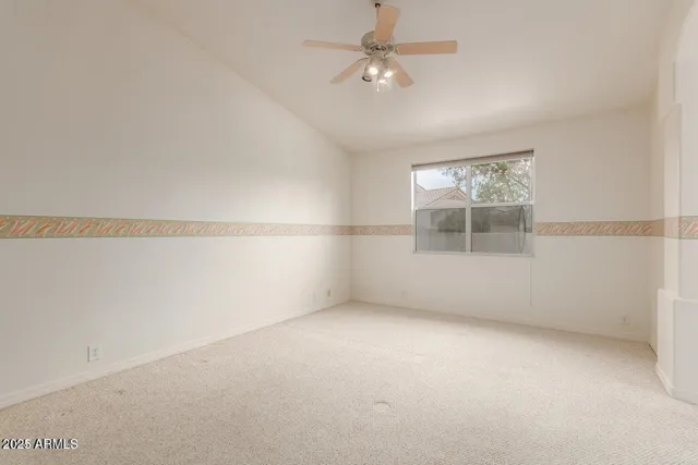 an empty room with a empty space and a ceiling fan