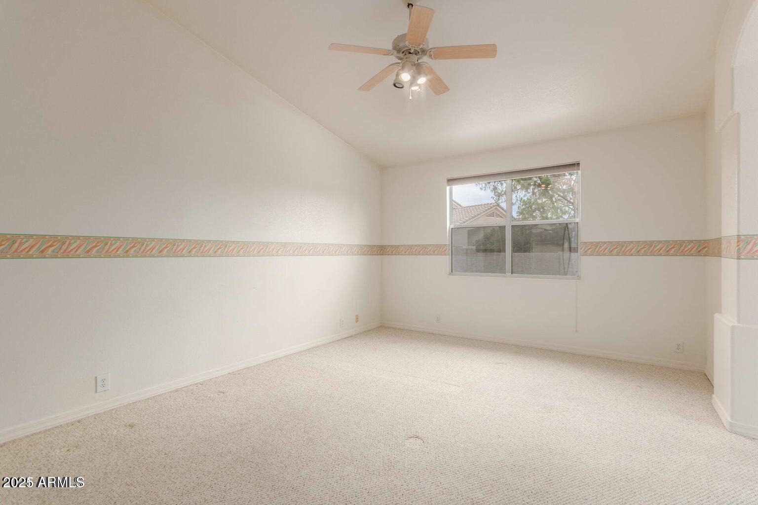 6230 West Irma Lane Glendale, AZ 85308 - Photo 19 of 21 an empty room with a empty space and a ceiling fan