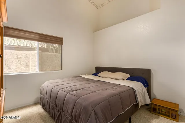 a bedroom with a bed and window