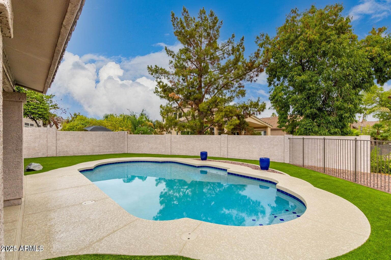 6230 West Irma Lane Glendale, AZ 85308 - Photo 5 of 21 a view of a swimming pool with a lounge chair