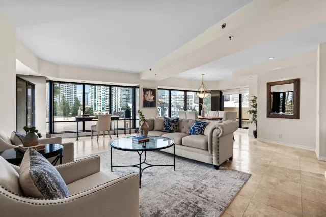 a living room with furniture and large windows