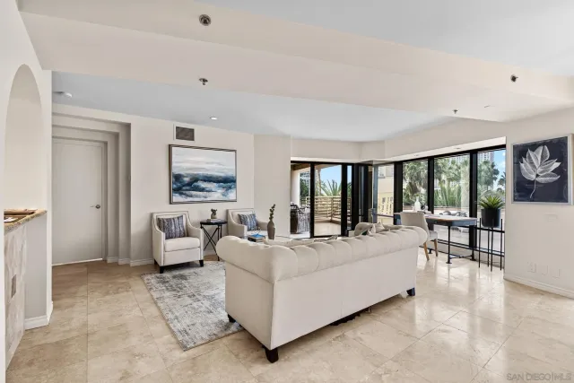 a living room with furniture and a floor to ceiling window
