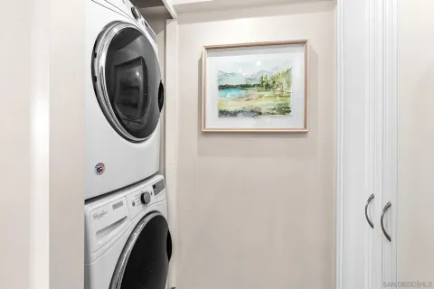 a bathroom with a granite countertop sink toilet and mirror