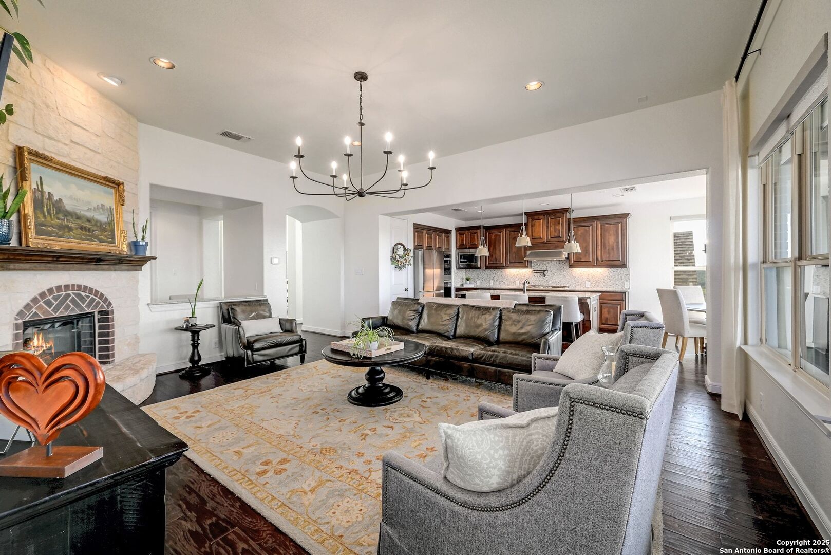 17023 Turin Ridge San Antonio, TX 78255 - Photo 12 of 48 a living room with furniture kitchen view and a chandelier