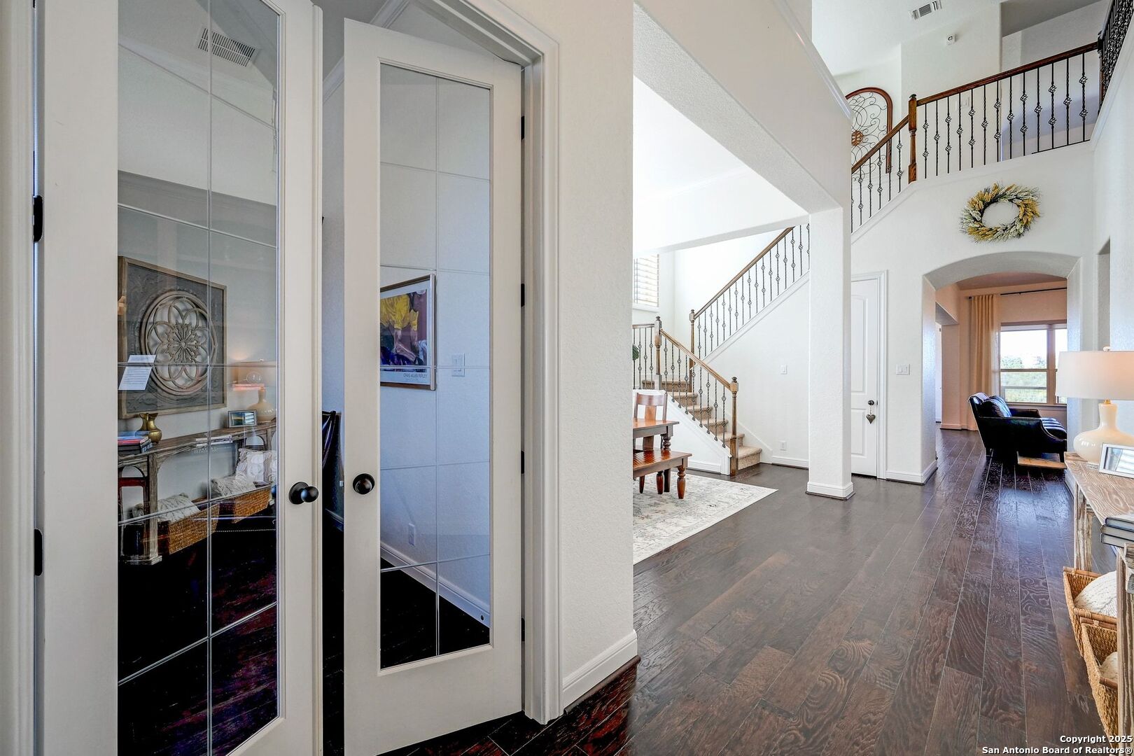 17023 Turin Ridge San Antonio, TX 78255 - Photo 20 of 48 a view of a hallway to a livingroom with wooden floor and furniture