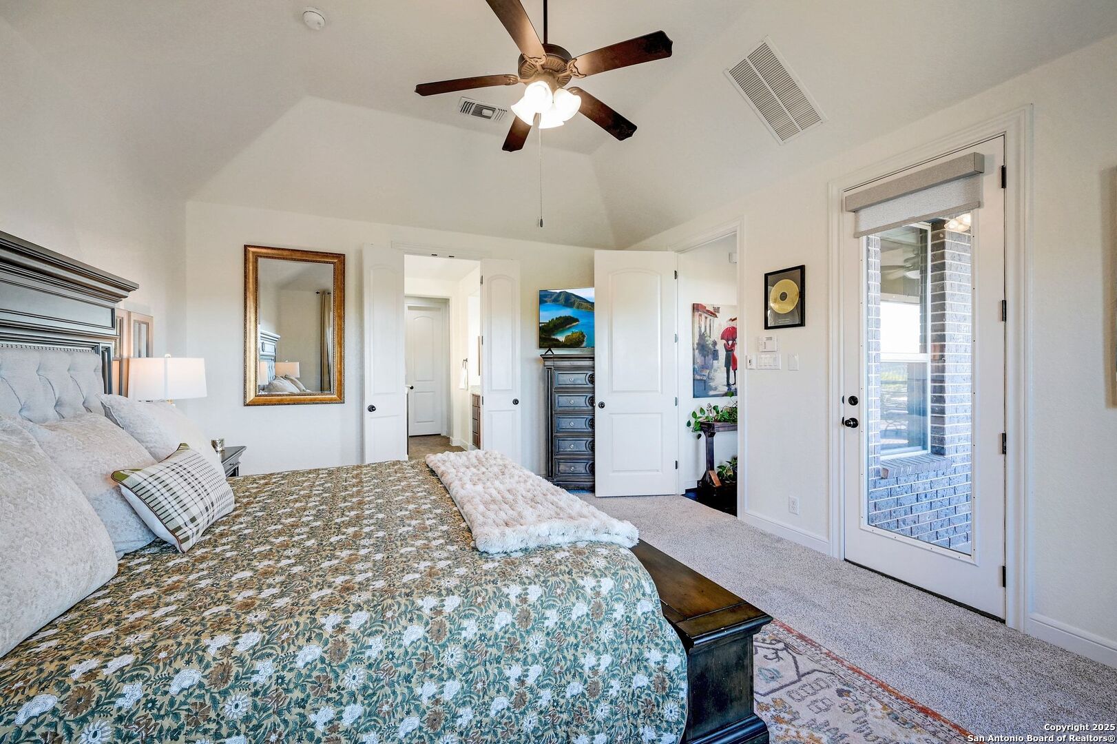 17023 Turin Ridge San Antonio, TX 78255 - Photo 23 of 48 a bedroom with a bed and a chandelier