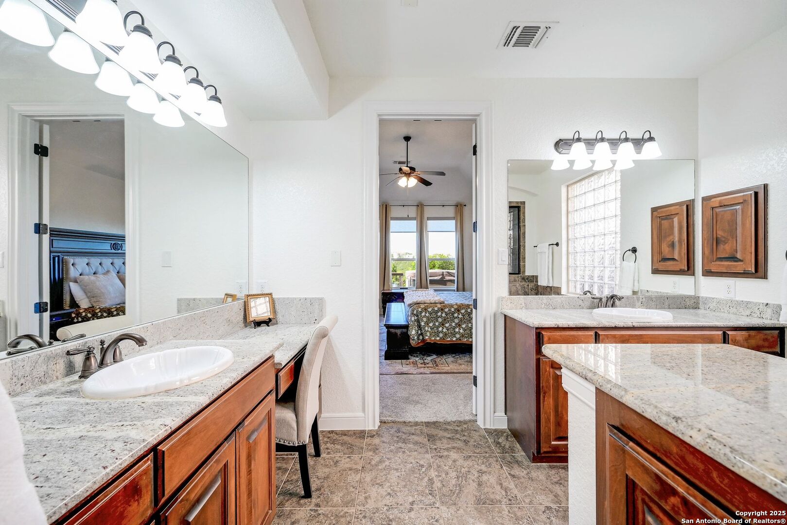 17023 Turin Ridge San Antonio, TX 78255 - Photo 26 of 48 a spacious bathroom with a granite countertop sink a mirror and a bathtub