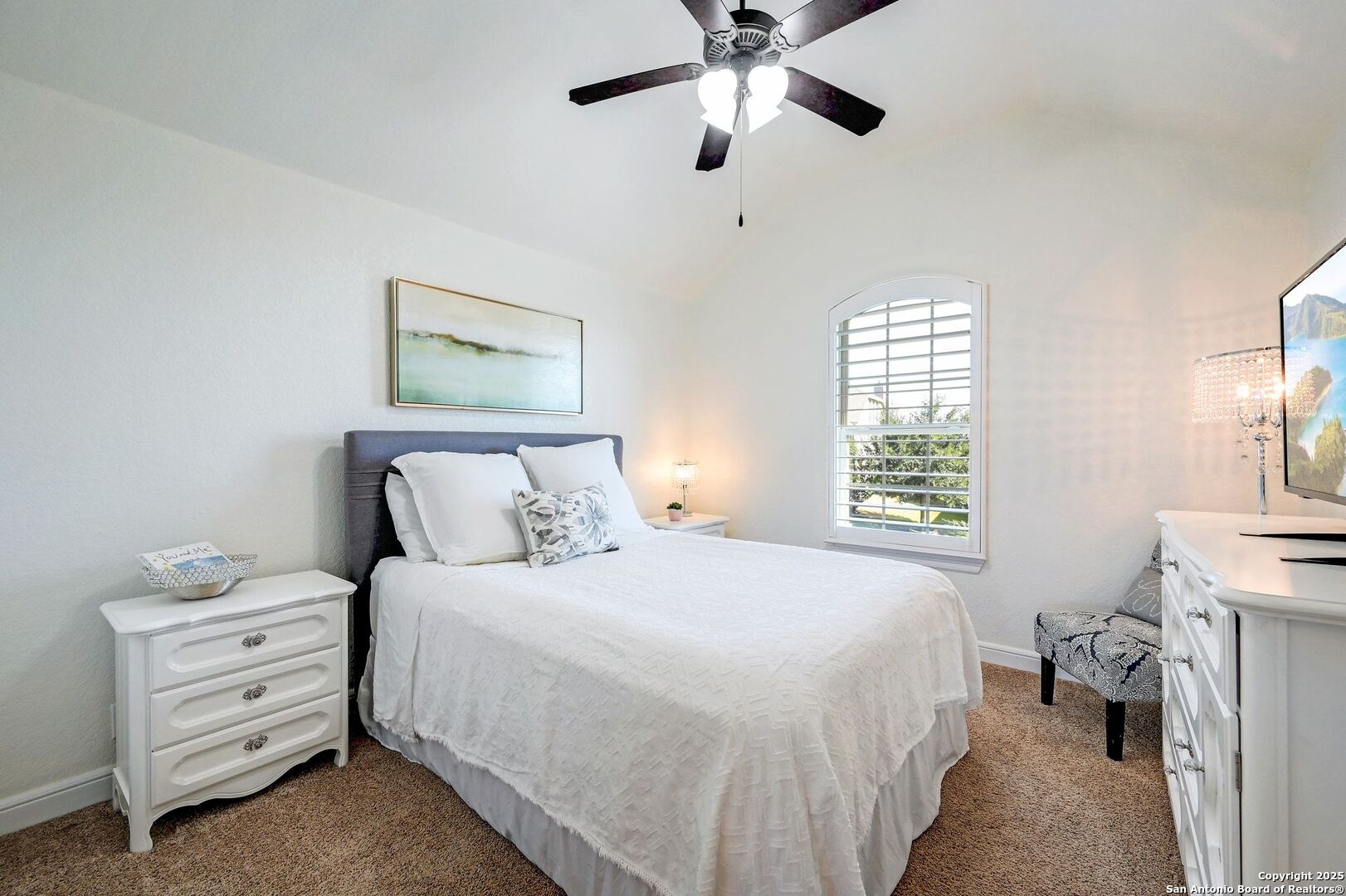 17023 Turin Ridge San Antonio, TX 78255 - Photo 32 of 48 a bedroom with a bed and a chandelier