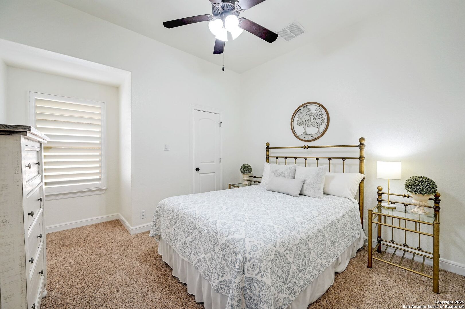 17023 Turin Ridge San Antonio, TX 78255 - Photo 34 of 48 a bedroom with a large bed and a chandelier