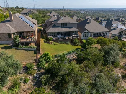 an aerial view of a house with garden space and a patio