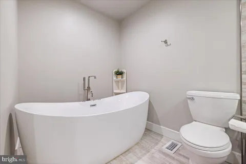a white toilet sitting next to a white sink
