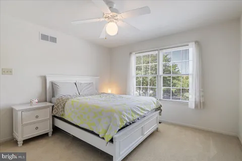 a bed sitting in a bedroom next to a window