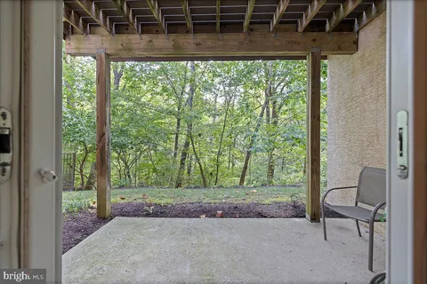a backyard of a house with a garden and outdoor seating