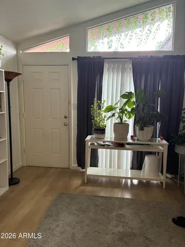 a living room with a fireplace furniture and a potted plant