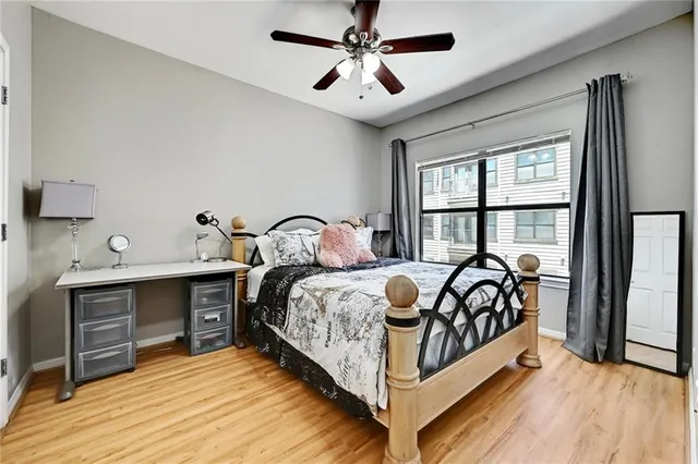 a bed sitting in a bedroom next to a window
