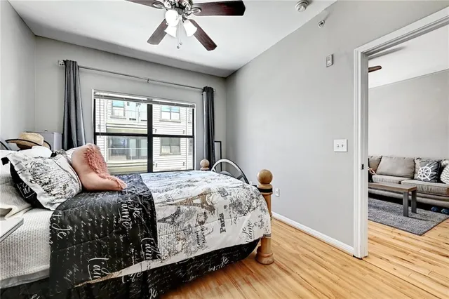 a bedroom with a bed and wooden floor