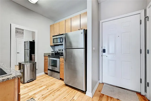 a kitchen with stainless steel appliances a refrigerator and a stove top oven