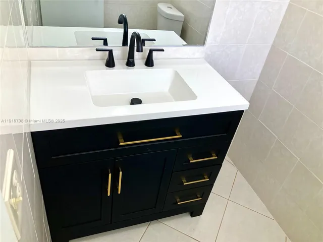 a view of a bathroom with a granite countertop sink