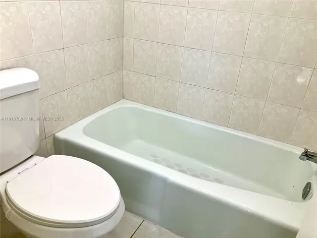 a view of a patio with table and chairs