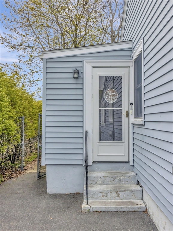 5 G Street Hull, MA 02045 - Photo 38 of 41 a view of house entrance to ceiling window with tree in front of it