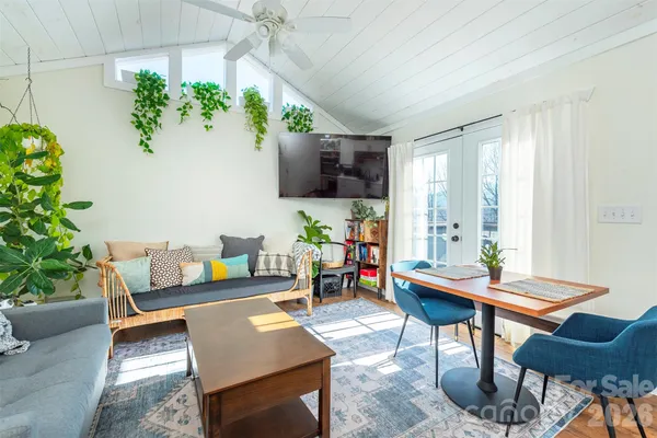 a living room with furniture and a potted plant