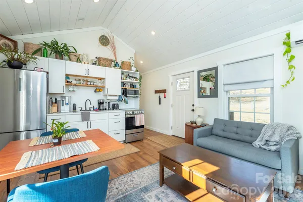 a bedroom with a bed and a potted plant