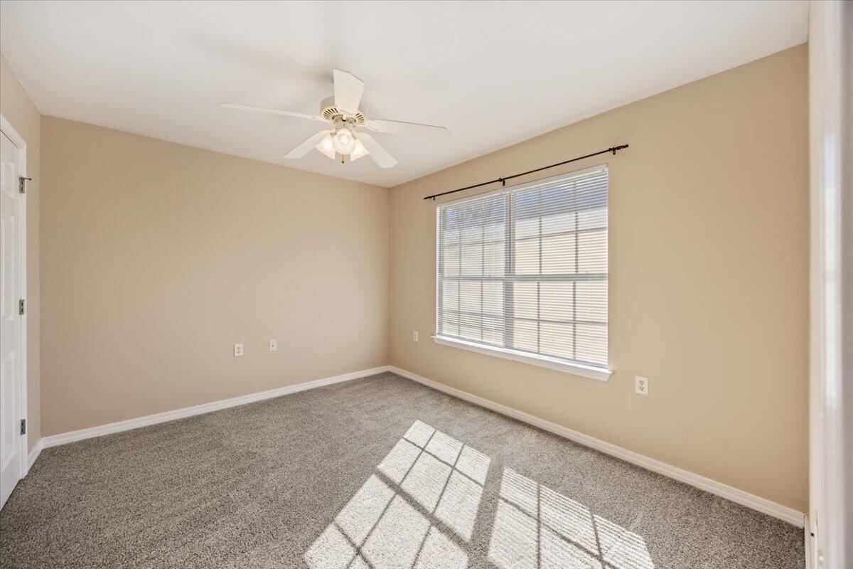 5414 Fawn Ridge Drive Gulf Breeze, FL 32563 - Photo 12 of 31 an empty room with chandelier fan and windows