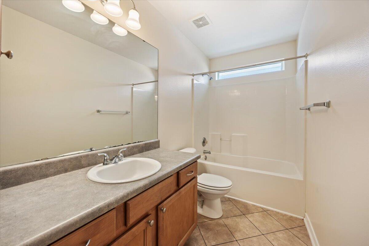 5414 Fawn Ridge Drive Gulf Breeze, FL 32563 - Photo 13 of 31 a bathroom with a granite countertop sink toilet and shower