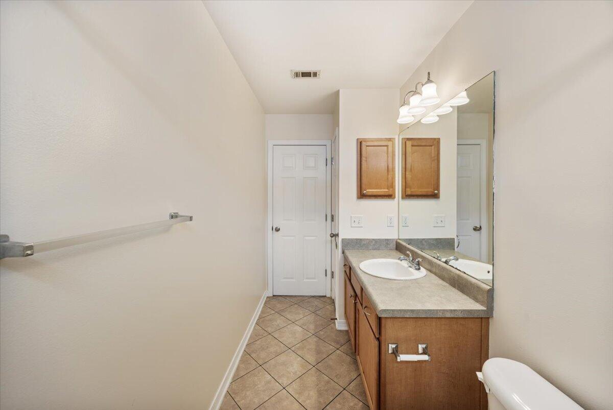 5414 Fawn Ridge Drive Gulf Breeze, FL 32563 - Photo 14 of 31 a bathroom with a sink toilet and mirror