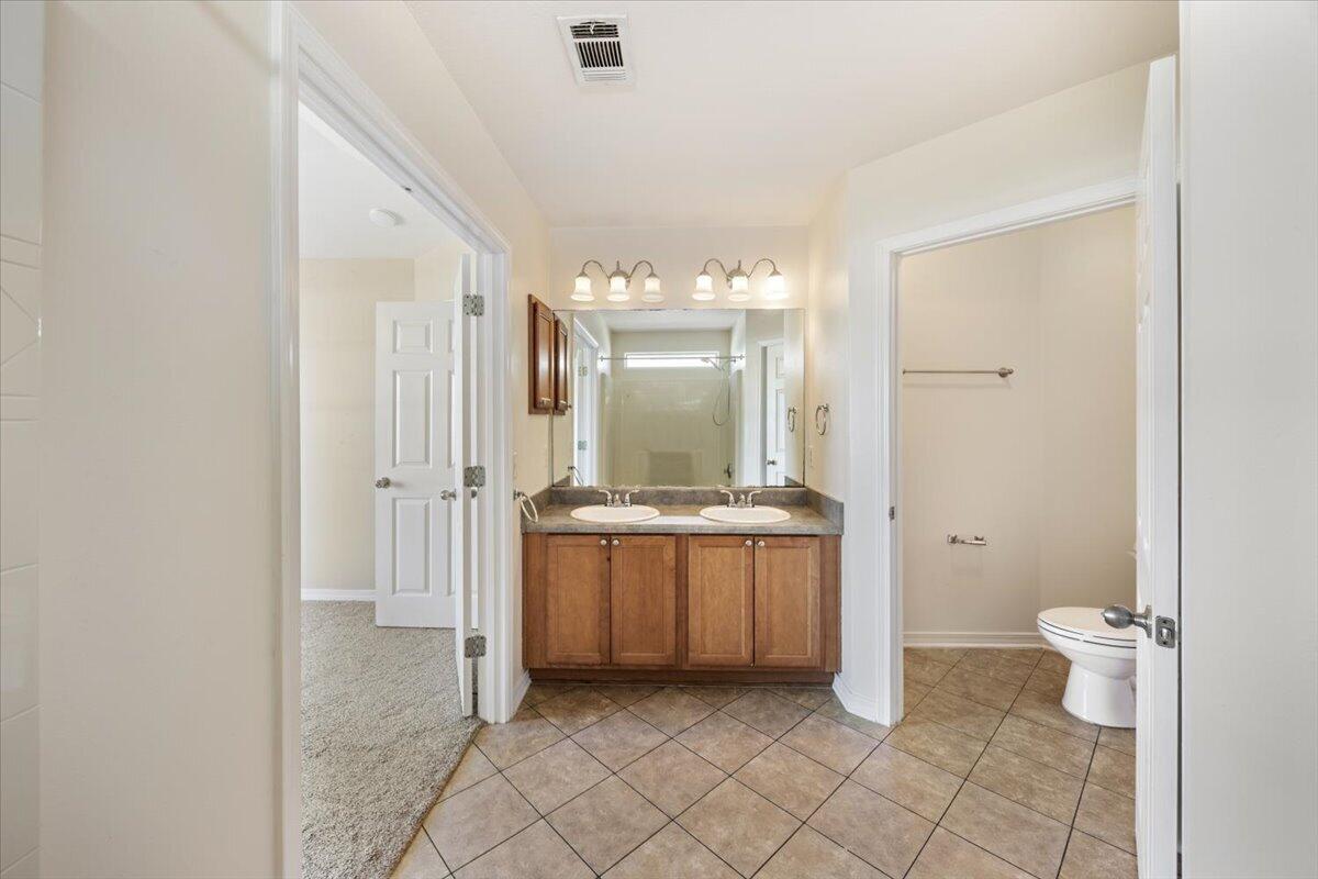 5414 Fawn Ridge Drive Gulf Breeze, FL 32563 - Photo 17 of 31 a bathroom with a granite countertop sink mirror and a toilet