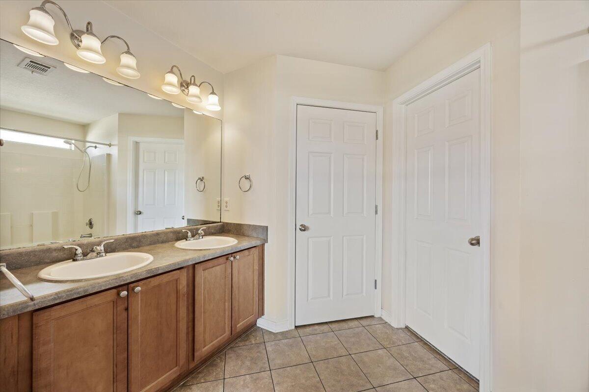 5414 Fawn Ridge Drive Gulf Breeze, FL 32563 - Photo 18 of 31 a spacious bathroom with a granite countertop sink a mirror and a shower