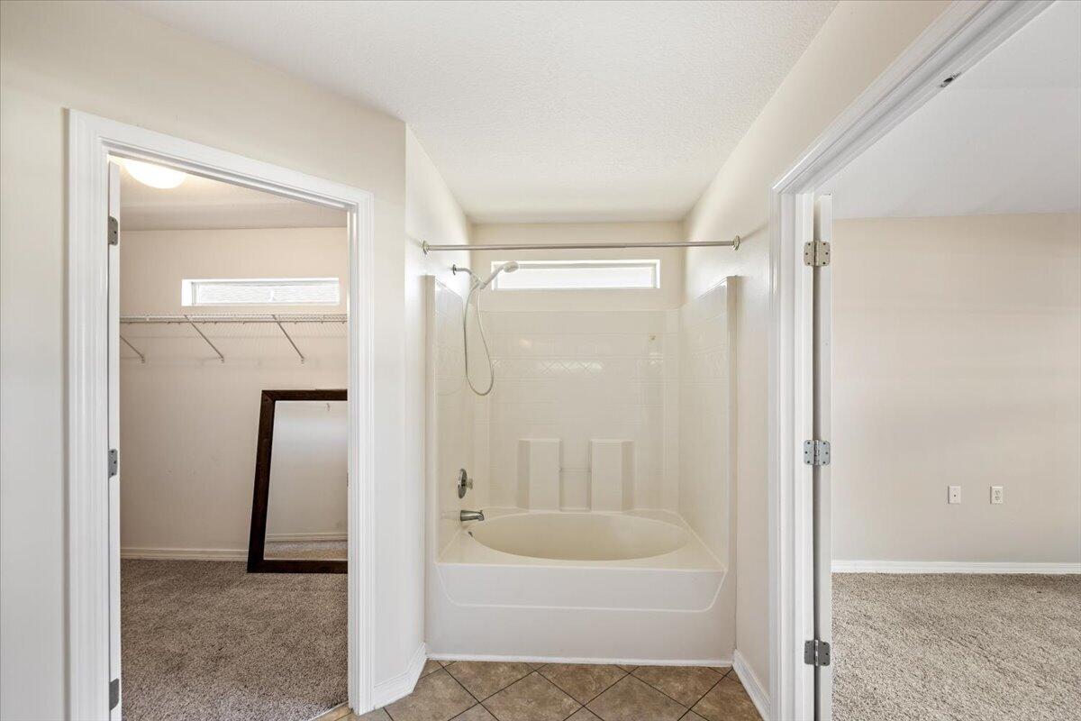 5414 Fawn Ridge Drive Gulf Breeze, FL 32563 - Photo 19 of 31 a bathroom with a bathtub and a shower