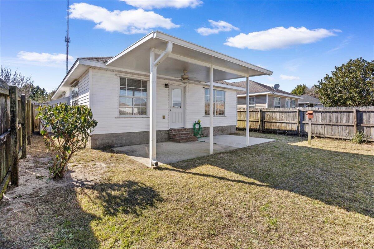 5414 Fawn Ridge Drive Gulf Breeze, FL 32563 - Photo 22 of 31 a front view of a house with a yard
