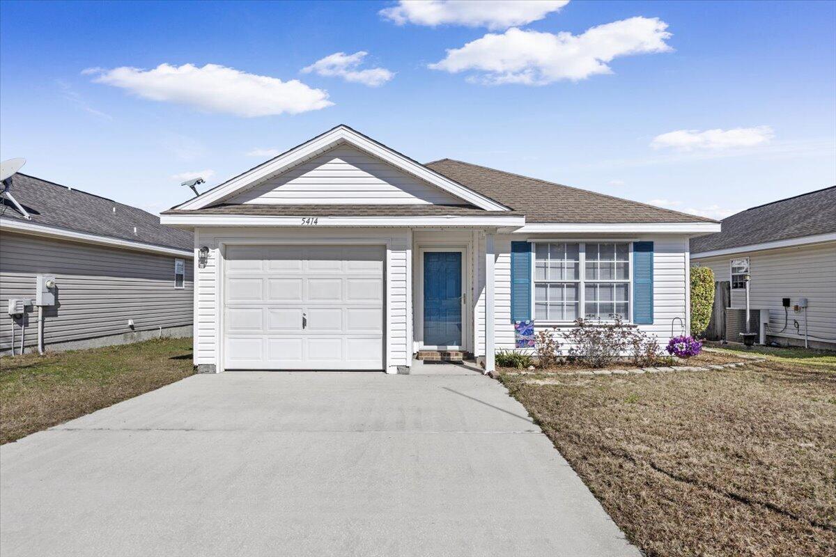 5414 Fawn Ridge Drive Gulf Breeze, FL 32563 - Photo 3 of 31 a front view of a house with a yard and garage