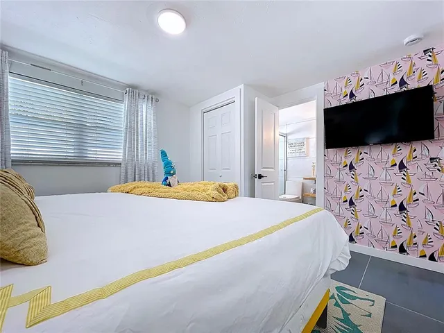 a bed sitting in a bedroom and a table