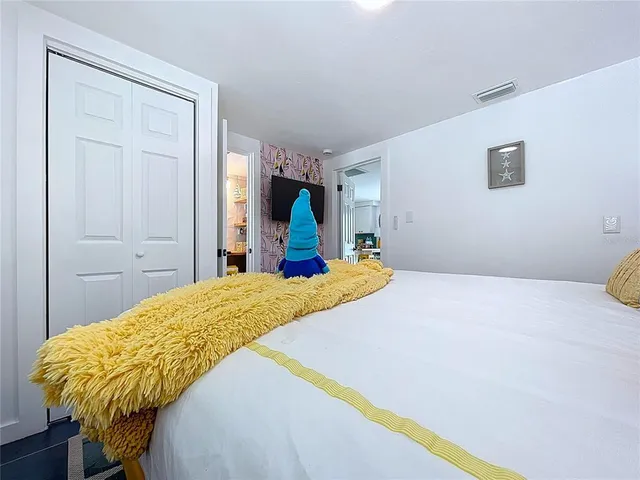 a bedroom with bed and cupboard