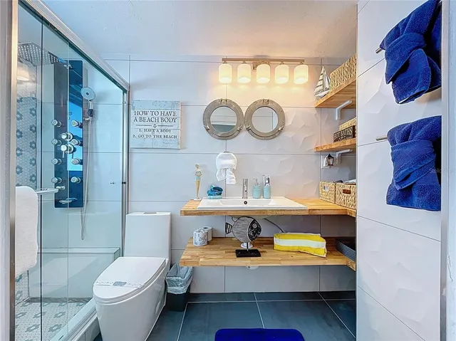 a bathroom with a toilet a sink and a mirror