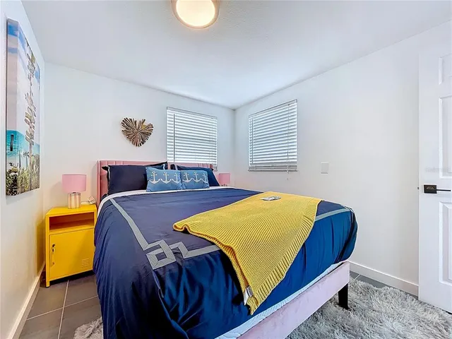 a bedroom with a bed and flat screen tv