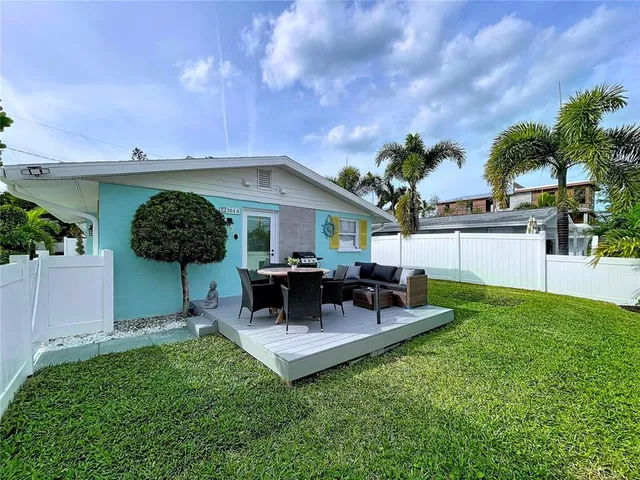 a view of a house with a backyard porch and sitting area