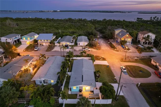 an aerial view of multiple houses with yard