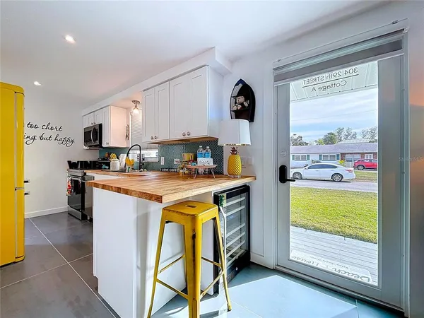 a kitchen with stainless steel appliances a stove a sink and a microwave