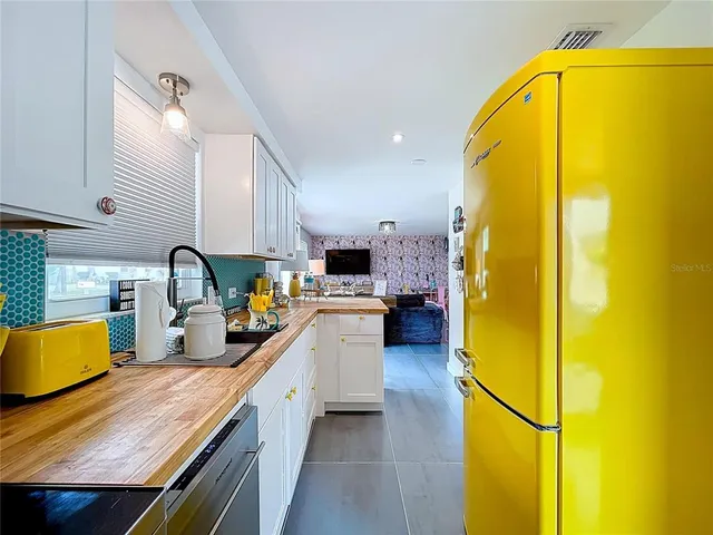 a kitchen with granite countertop a sink and a stove top oven