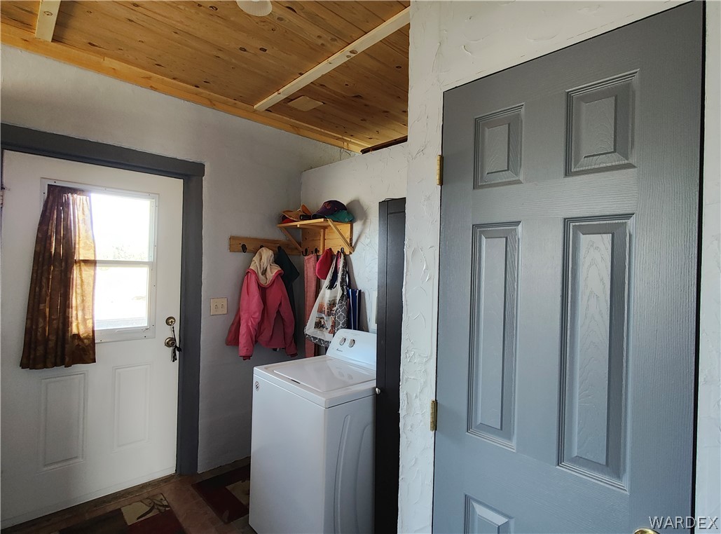15 County Road Concho, AZ 85924 - Photo 18 of 93 Utility space featuring a wood-finish ceiling, light gray walls, and a white exterior door with an upper window pane